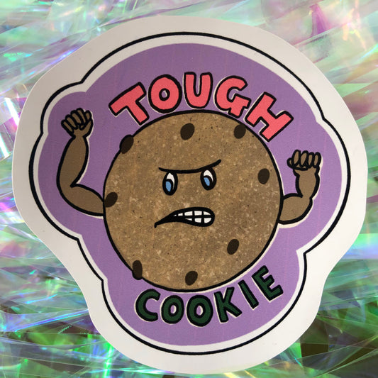 Image shows a vinyl sticker featuring an illustration of a cookie with muscles and the wording 'Tough Cookie'