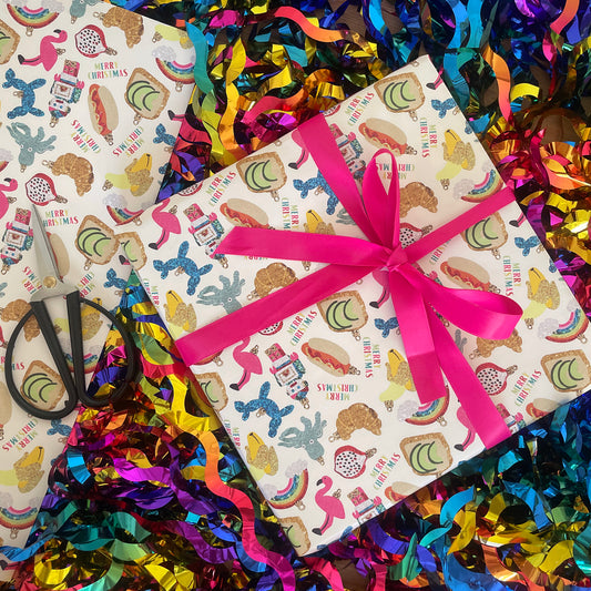 Image shows a wrapped gift fun trinkets gift wrap. The design features a quirky bauble pattern.