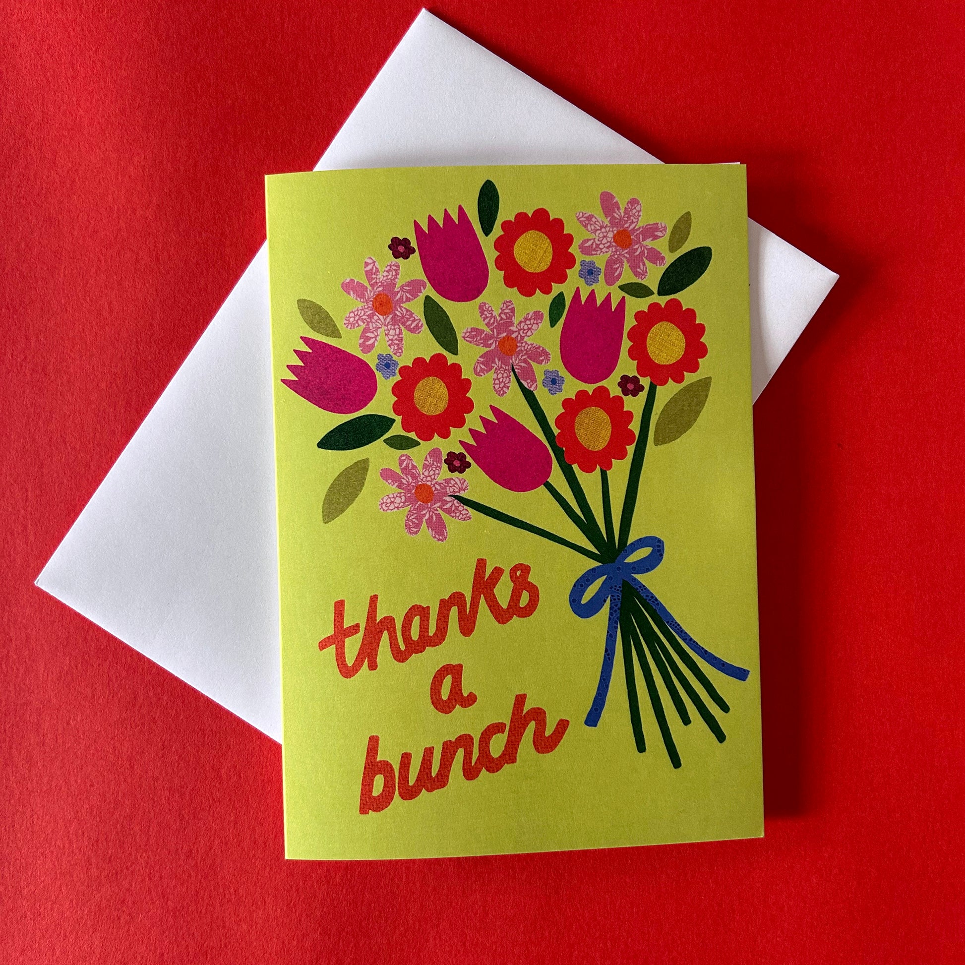 Greeting card with floral design and 'thanks a bunch' text on a red background