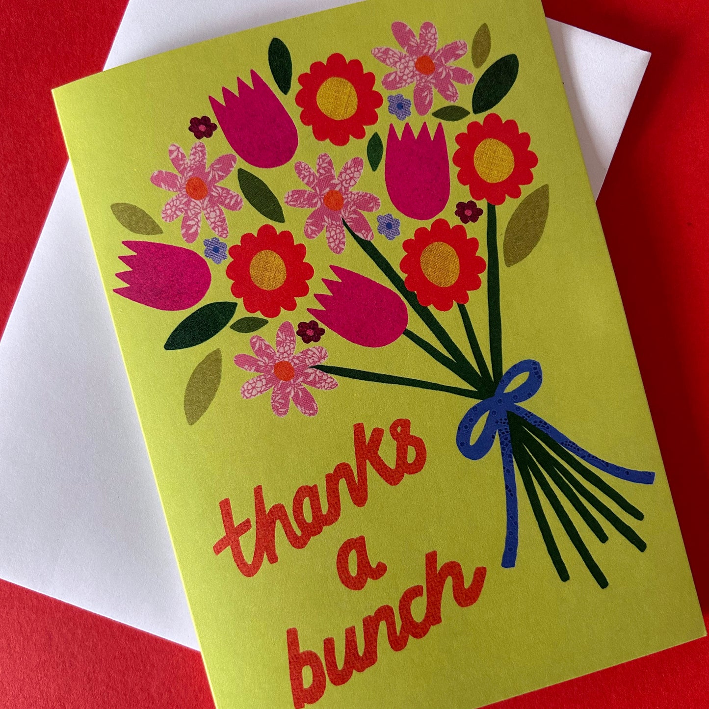 Greeting card with floral design and 'thanks a bunch' text on a red background