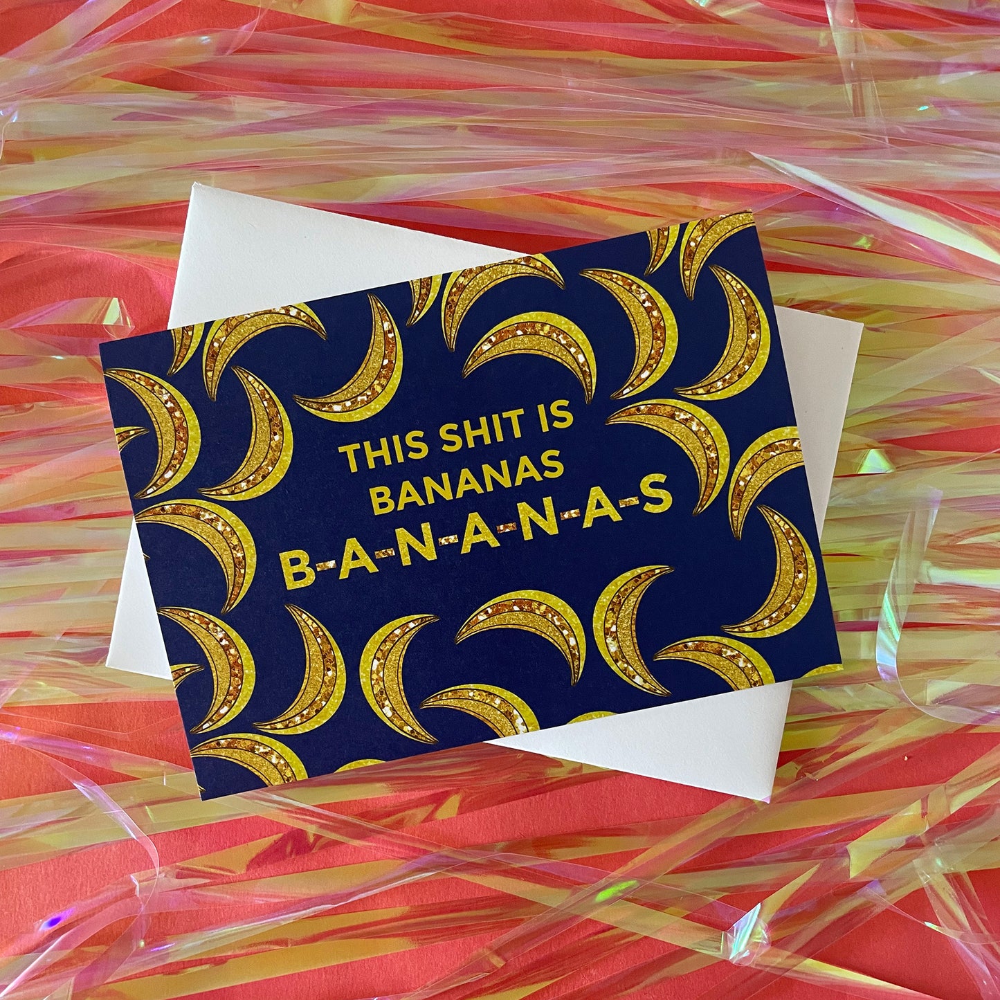 Image of a blue card featuring bejewelled illustrations of bananas and the message 'This Shit is Bananas B-A-N-A-N-A-S.