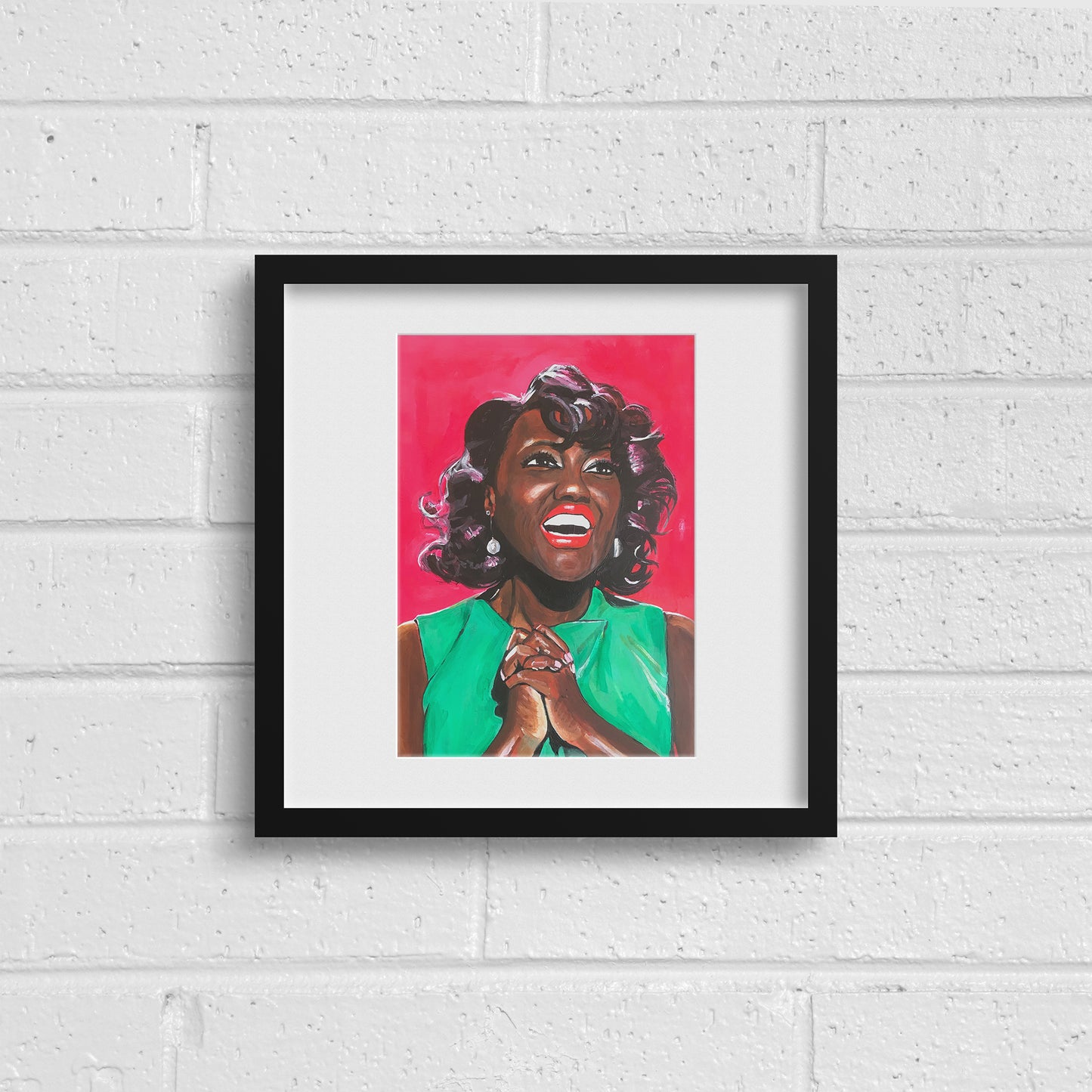 Image shows a joyful portrait of Viola Davis wearing a bright green dress, clasping her hands together and smiling on a bright pink background