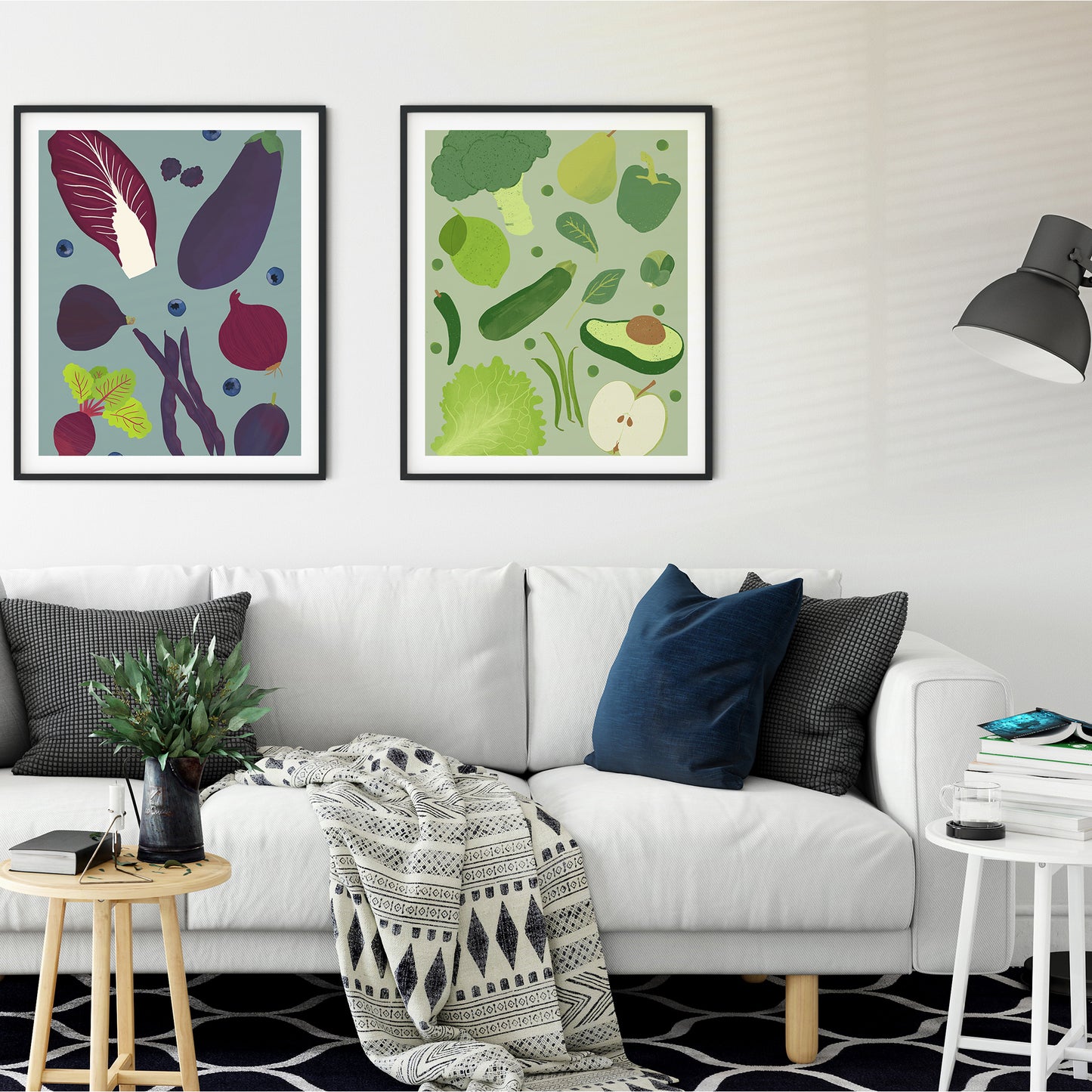 Image of two framed art prints of purple fruit and vegetables on a pale indigo background and green fruits and veg on a pale green background
