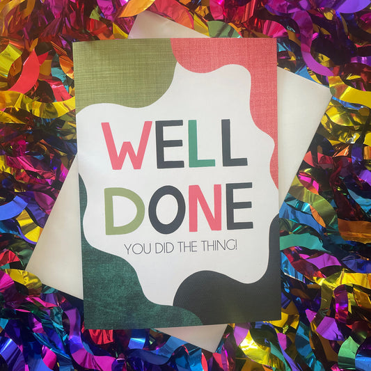 Image shows a bright greetings card with colourful, abstract shapes around the edge and the wording "Well Done you did the thing"