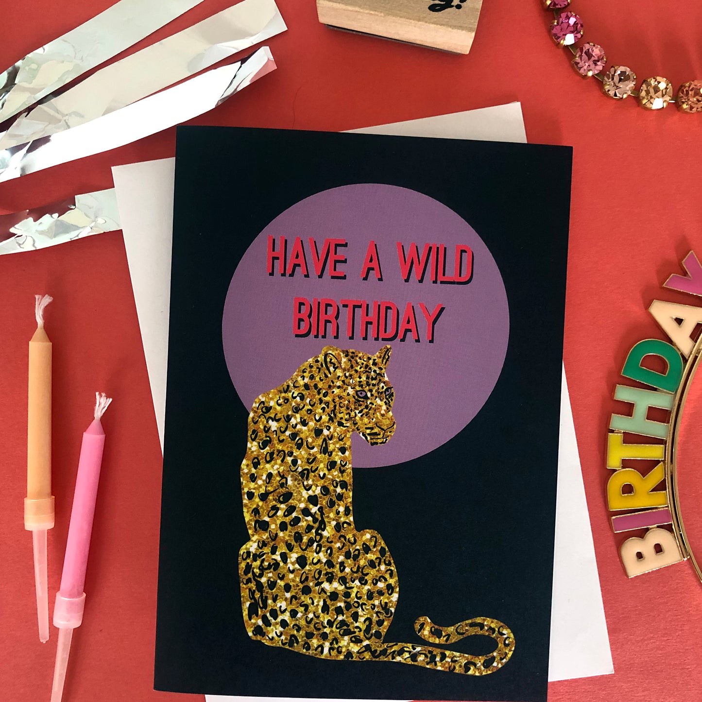 Wild birthday card featuring a gold glitter leopard in front of a lilac full moon.