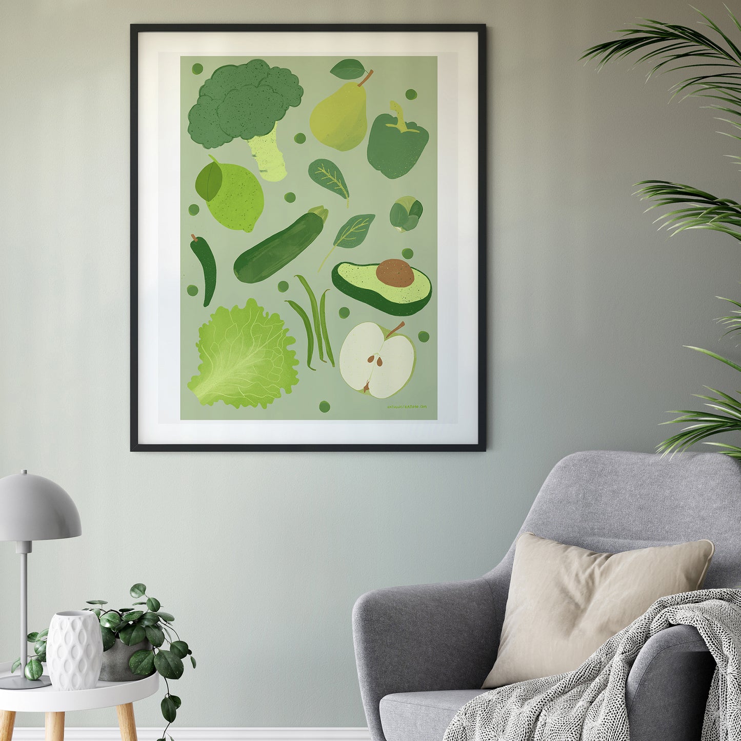Image of a framed art print of green fruit and vegetables on a green background.