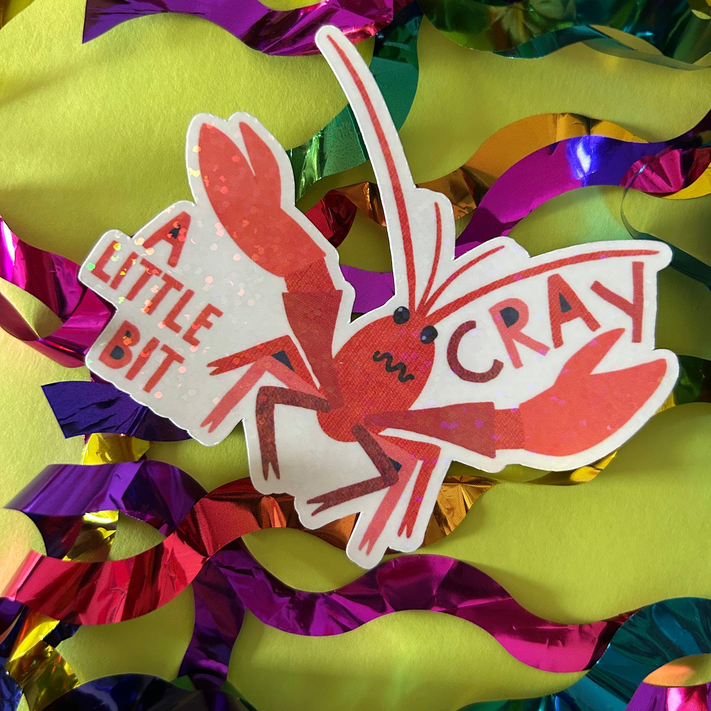 Sticker of a crayfish with 'A Little Bit Cray' text on colorful ribbons